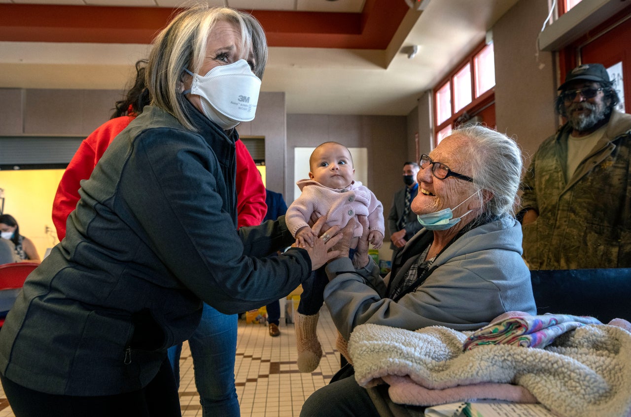 New Mexico Gov. Michelle Lujan Grisham, left, talks Connie Guinn and her granddaughter, Bella Guerrero Munoz, at the emergency evacuation center in Las Vegas, on April 25, 2022. The Calf Canyon Fire has forced the evacuation of Guinn and her family, from Laboux, and many residents of San Miguel and Mora County. 