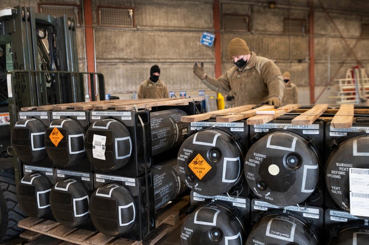 In this image provided by the U.S. Air Force, airmen and civilians from the 436th Aerial Port Squadron palletize ammunition, weapons and other equipment bound for Ukraine during a foreign military sales mission at Dover Air Force Base, Del., on Jan. 21, 2022.