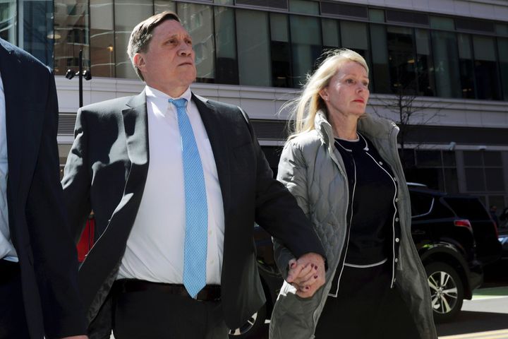 John Wilson, left, arrives at federal court in 2019 with his wife Leslie to face charges in a nationwide college admissions bribery scandal in Boston.