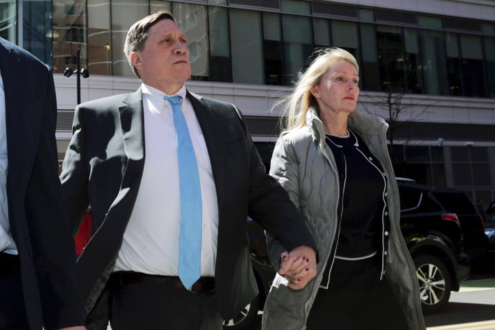 John Wilson, left, arrives at federal court in 2019 with his wife Leslie to face charges in a nationwide college admissions bribery scandal in Boston.