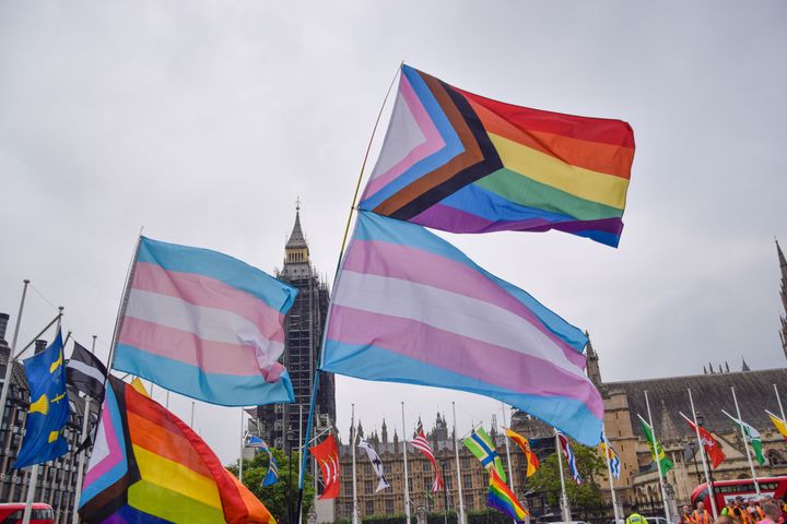 Pride and Trans flags are seen in Parliament Square.