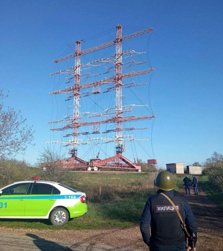 In this photograph released by the Press Center of the Ministry of Internal Affairs of the Pridnestrovian Moldavian Republic, a policeman stands by a radio station in Maiac, in the Moldovan separatist region of Trans-Dniester, Tuesday, April 26, 2022.