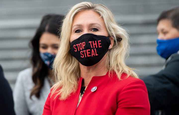 Rep. Marjorie Taylor Greene (R-Ga.) wears a "Stop the Steal" mask while speaking with fellow first-term Republican members of Congress on the steps of the Capitol in Washington, D.C., Jan. 4, 2021.