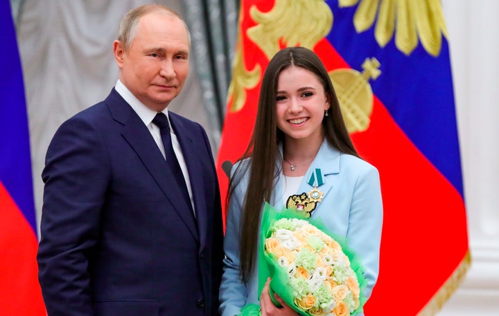 Russian President Vladimir Putin, left, poses for a photo with figure skater Kamila Valieva during an awarding ceremony for the Russian Olympic Committee's medalists of the Beijing Winter Olympics.