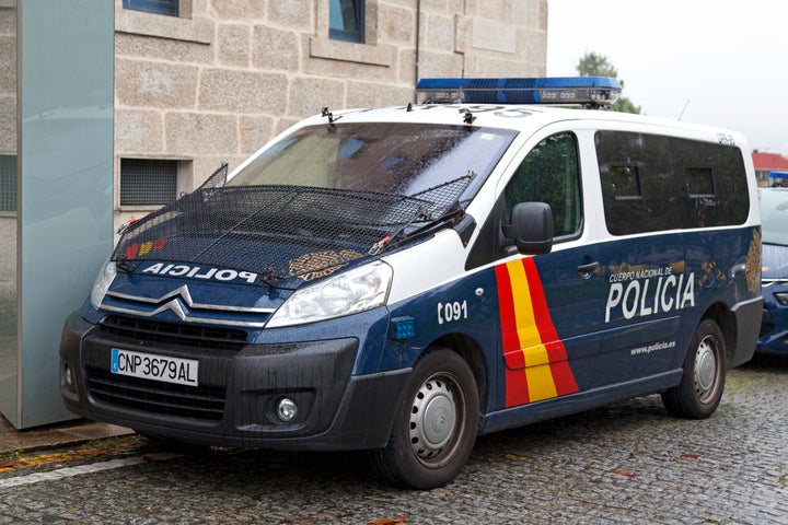 Santiago de Compostela, Spain - June 05 2018: A police van from the national police (Spanish: Policía Nacional) parked under the rain outside the police station.