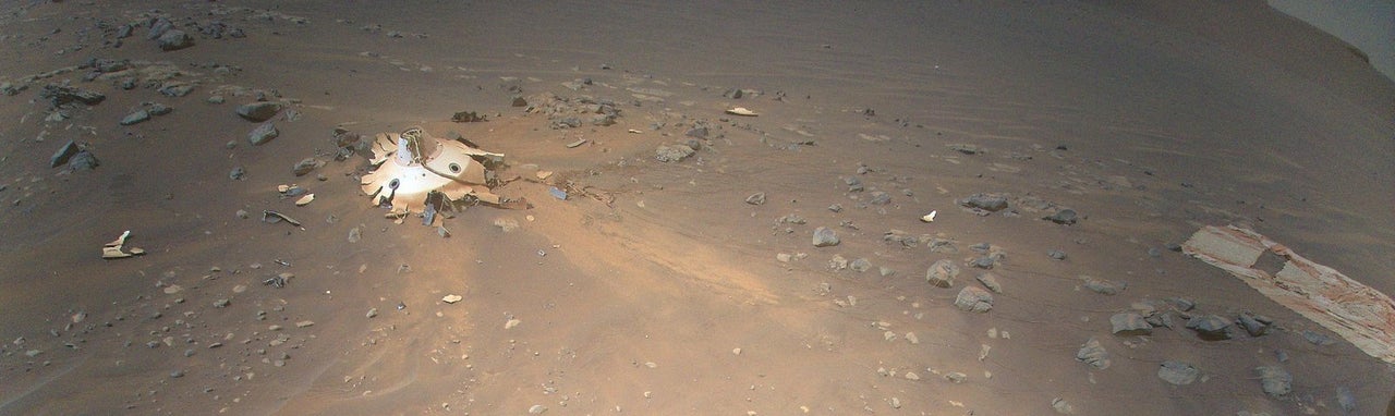 This image of Perseverance's backshell (left of center) and supersonic parachute (far right), was collected from an altitude of 26 feet by NASA's Ingenuity Mars Helicopter on April 19, 2022.