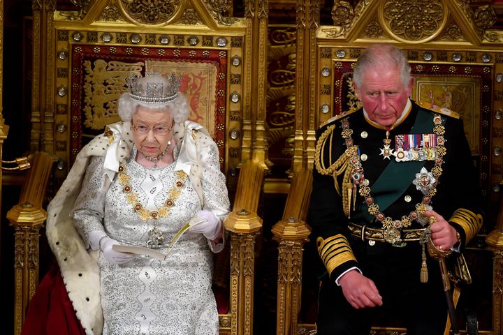 Queen Elizabeth II with Prince Charles, Prince of Wales as she delivers the Queen's Speech during the State Opening of Parliament at the Palace of Westminster on October 14, 2019