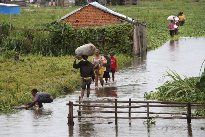 Residents wade through flood water around their homes after heavy rain in Antananarivo, the capital city of Madagascar, on Jan. 19.