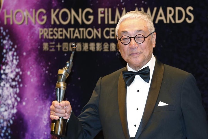 Tsang poses after winning the Best Supporting Actor award for his movie "Overhead 3" during the Hong Kong Film Awards on April 19, 2015.