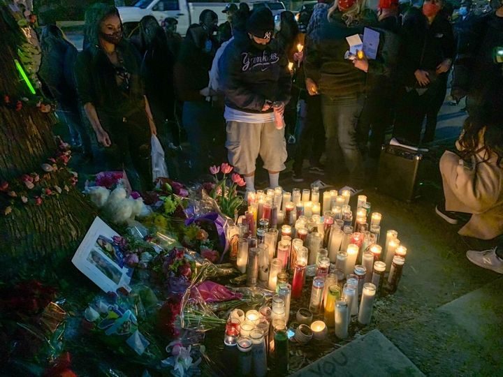 A candlelight vigil is held near the intersection where driver Monique Muñoz was killed.