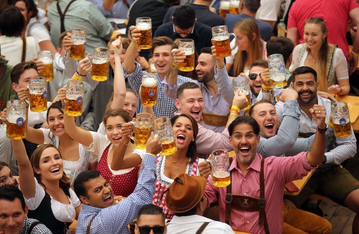 Revelers cheer with 1-liter-mugs of beer during the opening weekend of the 2019 Oktoberfest on September 21, 2019 in Munich, Germany.