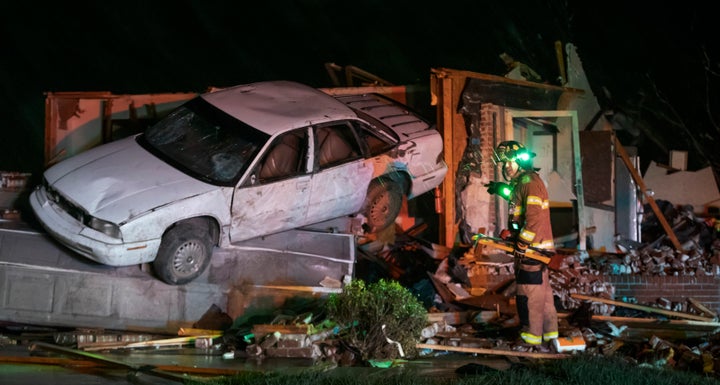 A Wichita, Kan., firefighter searches a home in Andover, Kan., Friday, April 29, 2022, after a tornado ripped through the area just east of Wichita.
