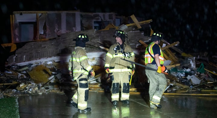 Firefighters search a home in Andover, Kan., Friday, April 29, 2022, after a tornado ripped through the area just east of Wichita.