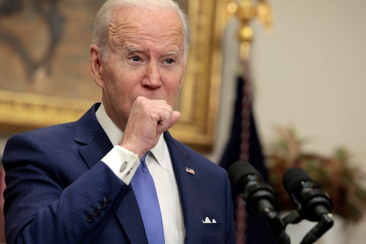 U.S. President Joe Biden coughs as he gives remarks on providing additional support to Ukraine’s war efforts against Russia from the Roosevelt Room of the White House on April 28, 2022 in Washington, DC.