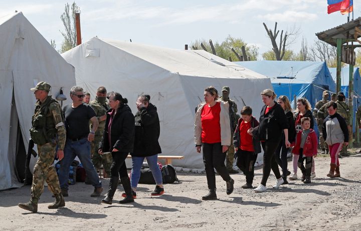 Civilians who left the area near Azovstal steel plant in Mariupol walk at a temporary accommodation centre during Ukraine-Russia conflict in the village of Bezimenne in the Donetsk Region, Ukraine May 1, 2022. REUTERS/Alexander Ermochenko