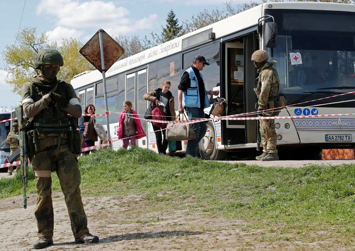 Civilians who left the area near Azovstal steel plant in Mariupol board a bus accompanied by a UN staff member near a temporary accommodation centre during Ukraine-Russia conflict in the village of Bezimenne in the Donetsk Region, Ukraine May 1, 2022. REUTERS/Alexander Ermochenko