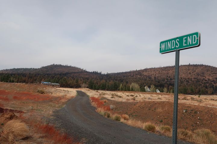 This photograph taken on Tuesday, April 26, 2022, shows the hills above the Girls Ranch neighborhood outside Flagstaff, Arizona, blackened by a massive wildfire that swept through the area.  The fire that started on Easter Sunday burned about 30 square kilometers and more than a dozen houses, yellowing across the parched landscape.