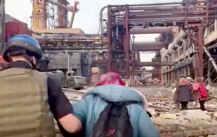 This frame taken from an undated video provided Sunday, May 1, 2022 by the Azov Special Forces Regiment of the Ukrainian National Guard shows people walking over debris at the Azovstal steel plant, in Mariupol, eastern Ukraine. As many as 100,000 people may still be in Mariupol, including an estimated 2,000 Ukrainian fighters beneath the sprawling, Soviet-era steel plant — the only part of the city not occupied by the Russians.
