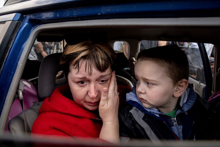 Natalia Pototska, 43, cries as her grandson Matviy looks on in a car at a center for displaced people in Zaporizhzhia, Ukraine on Monday. They were part of a group of more than 100 people who fled Mariupol’s rubble-strewn Azovstal steelworks.