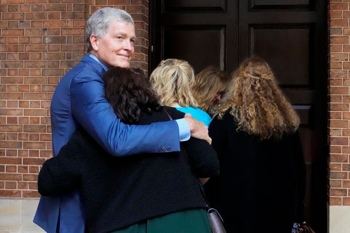 Steve Johnson, brother of U.S. murder victim Scott Johnson, hugs his wife Rosemarie as they arrive at the Supreme Court in Sydney on Monday.