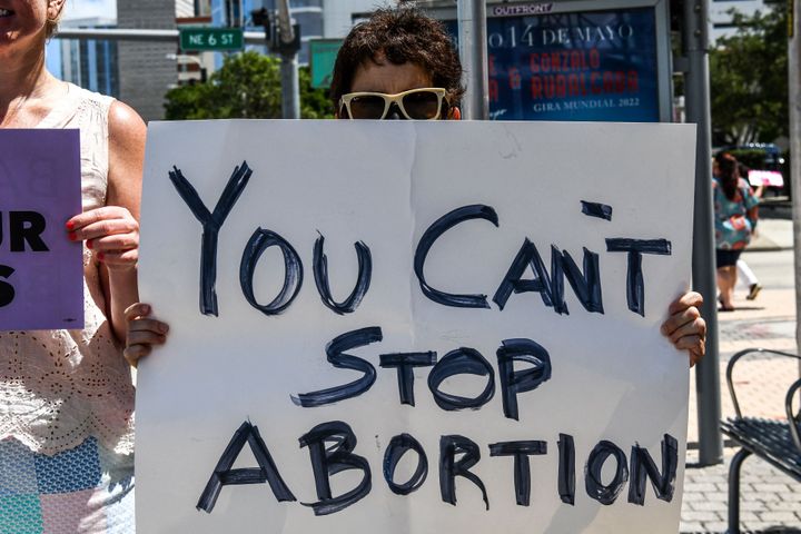 Pro-choice demonstrators hold placards in front of the Freedom Tower in Miami on May 3, 2022.