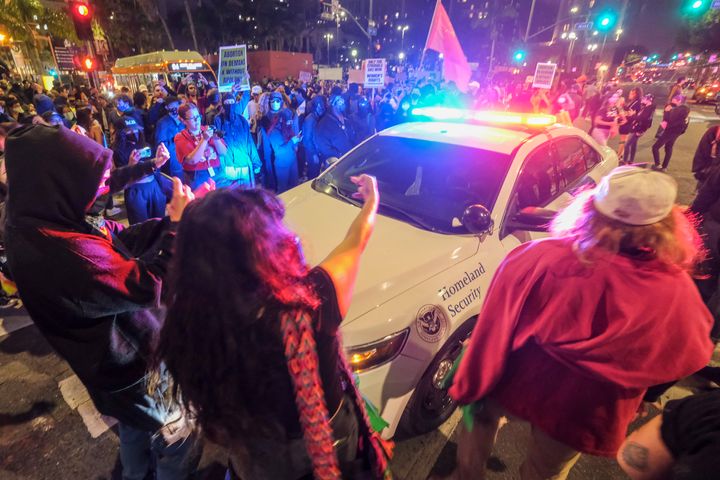 Demonstrators surround a police officer in his vehicle near Pershing Square in Los Angeles on Tuesday night after protesting outside the U.S. Courthouse in response to leaked draft of the Supreme Court's opinion to overturn Roe v. Wade. 