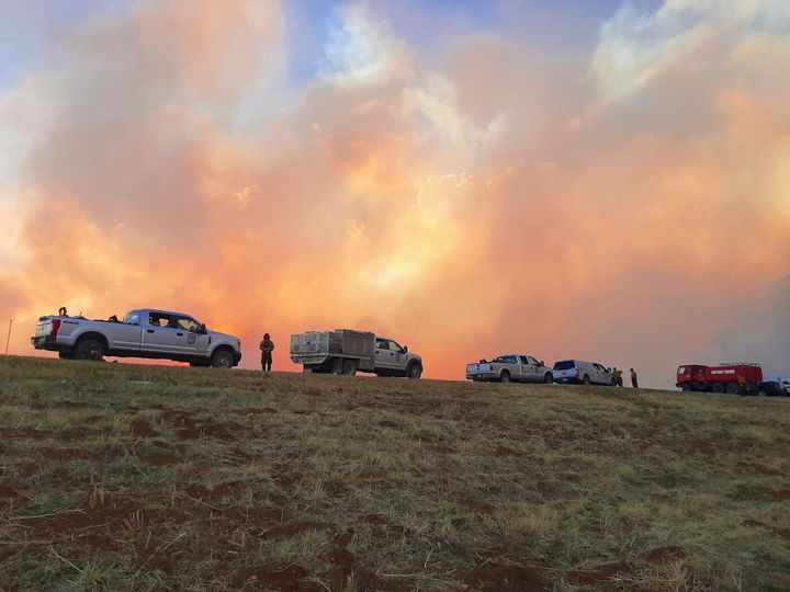 In this Sunday, May 1, 2022 photo provided by Jasper Bivens of Grayback Forestry, plumes of smoke from wildfires are seen from Highway 518, a few miles north of Las Vegas, New Mexico.