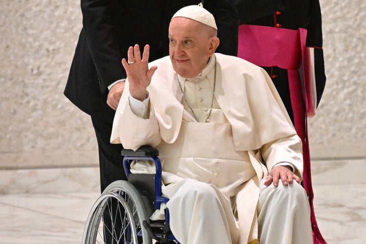 Pope Francis waves as he arrives at a Vatican conference on Thursday.