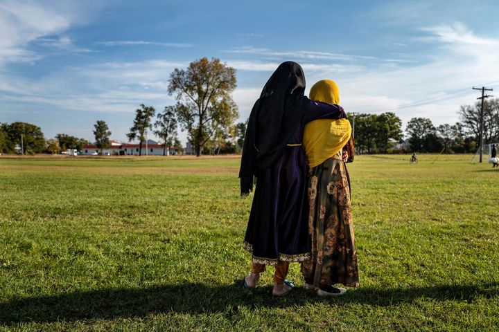 Afghan refugee girls watch a soccer match near where they are staying in the Village at the Fort McCoy U.S. Army base on Sept. 30, 2021, in Wisconsin.