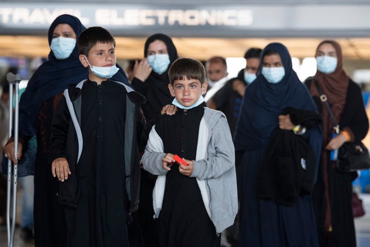 Afghan refugees arrive to Dulles International Airport on Aug. 27, 2021, after leaving Afghanistan as it fell to the Taliban.