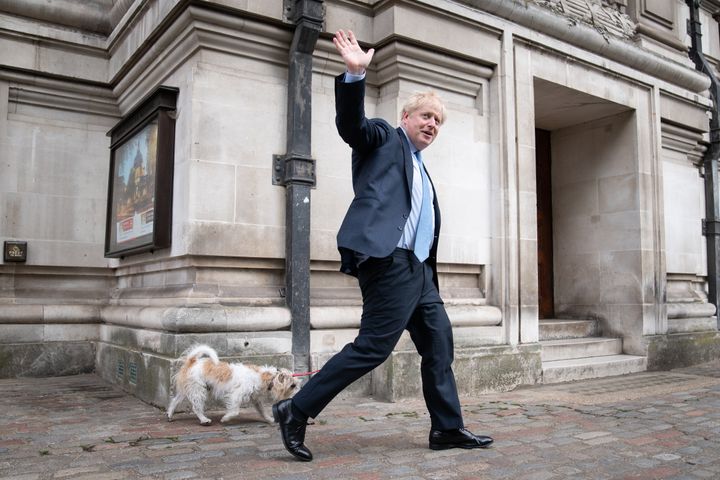 Boris Johnson leaves Methodist Central Hall in London with his dog, Dilyn, after voting in the local government elections.