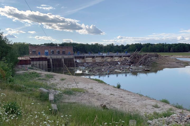 Debris rests at the spillway of the Sanford Dam in downtown Sanford, Mich., Thursday, July 30, 2020.