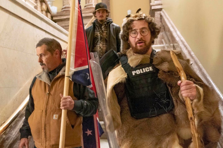 Supporters of President Donald Trump, including Aaron Mostofsky, right, who is identified in his arrest warrant, walk down the stairs outside the Senate Chamber in the U.S. Capitol, in Washington, D.C., on Jan. 6, 2021.