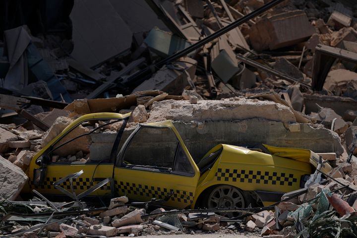 A taxi is buried in rubble at the site of the five-star Hotel Saratoga after a deadly explosion in Old Havana, Cuba.