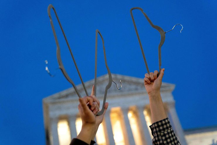 Pro-choice demonstrators hold coat hangers, a symbol of the reproductive rights movement, outside the Supreme Court in Washington, D.C., on May 3, 2022.