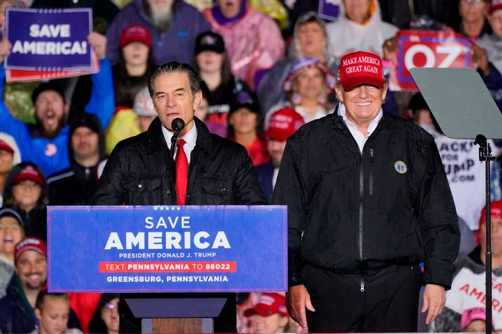 U.S. Senate candidate Mehmet Oz, left, accompanied by former President Donald Trump, speaks at a campaign rally in Greensburg, Pennsylvania, on Friday.