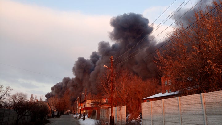 In this March 17, 2022 photo provided by astronomer Ivan Slyusarev, smoke rises from the Barabashovo market in Kharkiv, Ukraine, after it was hit by shelling.