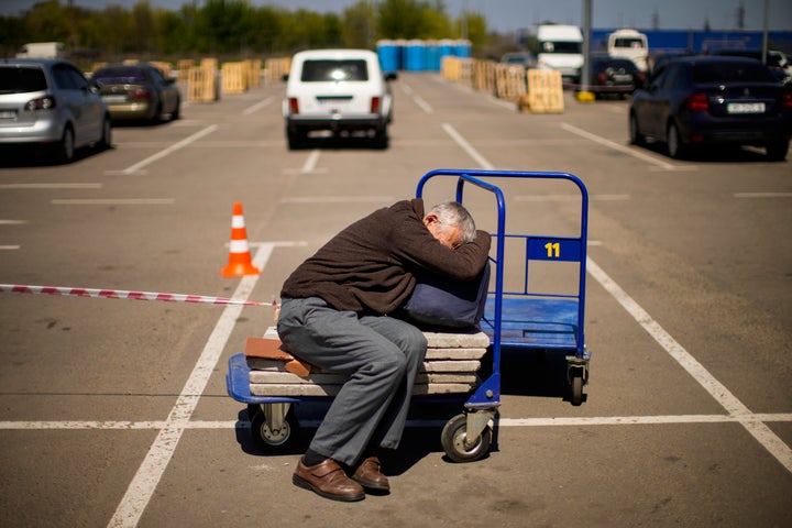 A man who fled from a small village near Polohy rests upon his arrival to a reception center for displaced people in Zaporizhzhia, Ukraine, Sunday, May 8, 2022. Thousands of Ukrainian continue to leave Russian occupied areas. (AP Photo/Francisco Seco)