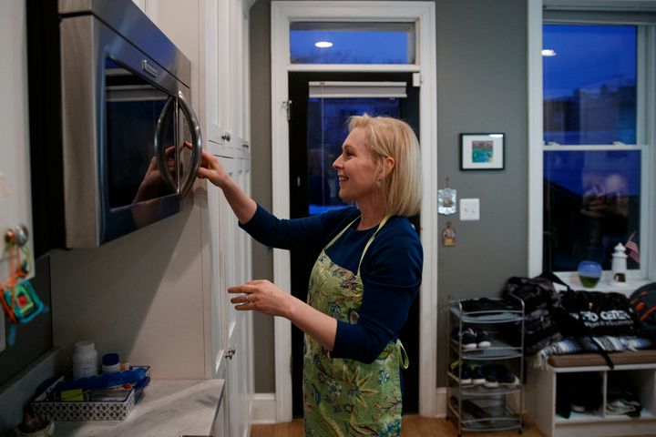 Sen. Kirsten Gillibrand, D-N.Y., uses the microwave as she cooks dinner at her home in Washington, Tuesday, Feb. 12, 2019. (AP Photo/Carolyn Kaster)
