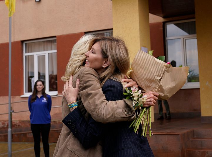 First lady Jill Biden hugs Olena Zelenskyy, spouse of Ukrainian's President Volodymyr Zelenskyy, outside of a public school that has taken in displaced students in Uzhhorod, Ukraine, on Sunday.