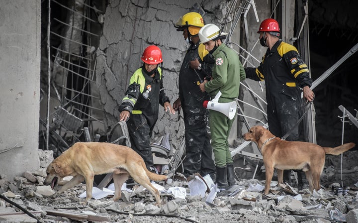 Firefighters and rescue workers remove debris from the ruins of the Saratoga Hotel, in Havana, on May 8, 2022.