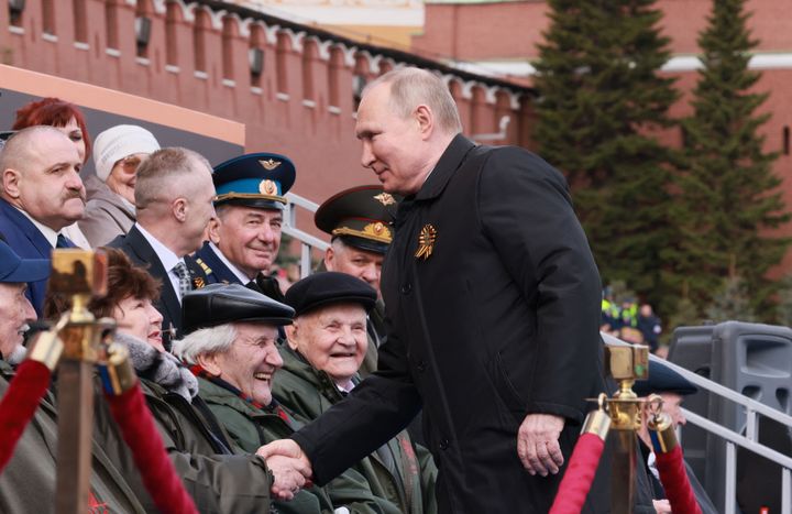 Russian President Vladimir Putin greets veterans as he arrives to watch the Victory Day military parade at Red Square in central Moscow on May 9, 2022.