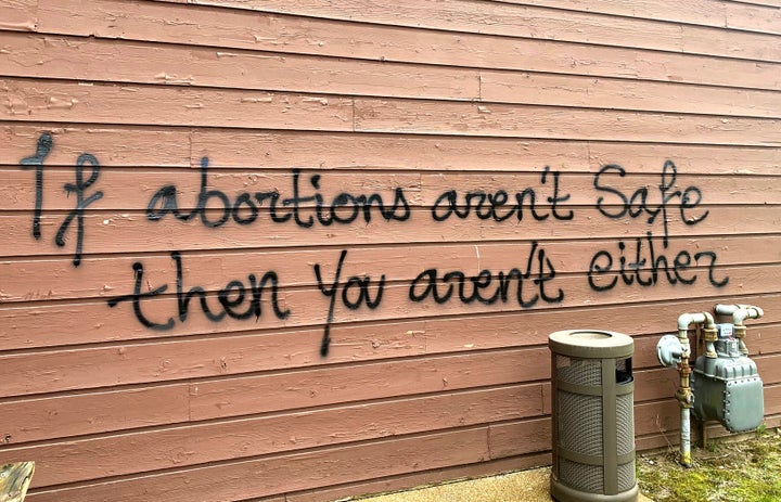 Threatening graffiti is seen on the exterior of Wisconsin Family Action offices in Madison, Wis., on May 8, 2022.