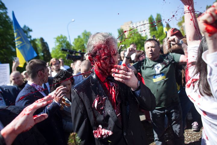 The Russian ambassador to Poland was covered in fake blood during a visit to Warsaw on Monday