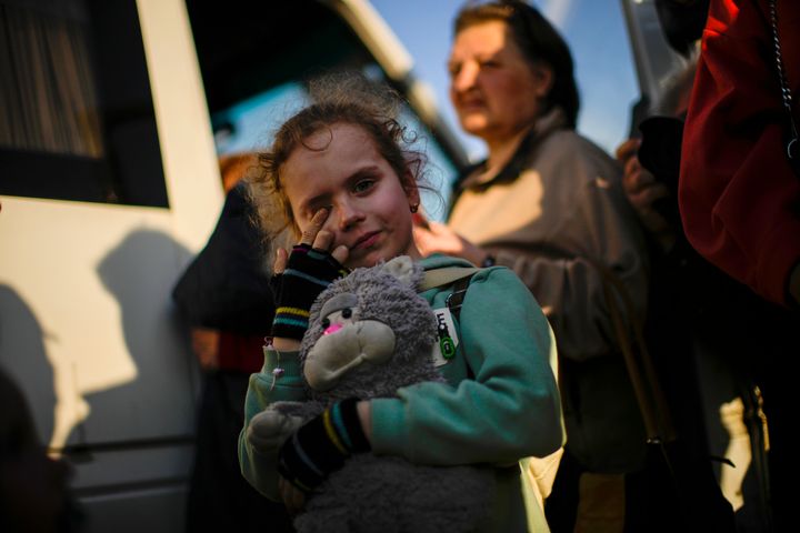 A child and her family who fled from Mariupol arrive at a reception center for displaced people in Zaporizhzhia, Ukraine, Sunday, May 8, 2022. Thousands of Ukrainians continue to leave Russian-occupied areas. (AP Photo/Francisco Seco)