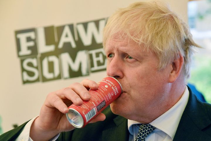 Prime Minister Boris Johnson drinks a Flawsome! drink at a stall during an event to promote British businesses at Downing Street.