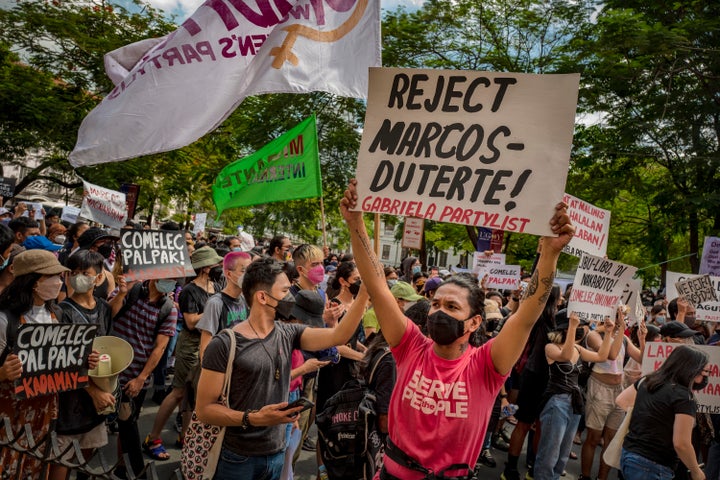 Filipinos take part in a protest against election results outside the Commission on Elections building on May 10, 2022 in Manila, Philippines. Ferdinand "Bongbong" Marcos Jr. is poised to win the presidency in a hotly contested election marred by several incidents of violence and numerous complaints of faulty vote counting machines. Marcos, the son and namesake of ousted dictator Ferdinand Marcos Sr. who was accused and charged of amassing billions of dollars of ill-gotten wealth as well as committing tens of thousands of human rights abuses during his autocratic rule, mounted a hugely popular campaign based largely on disinformation to return his family name to power. Election results a day after millions of Filipinos went to polls show Marcos enjoying a massive lead against main rival Vice President Leni Robredo. Also poised to win the vice presidency is Mayor Sara Duterte of Davao City, the daughter of outgoing President Rodrigo Duterte who is the subject of an international investigation for alleged human rights violations during his war on drugs.