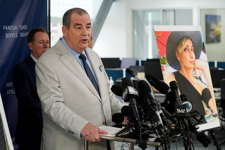 Brian Panish, an attorney for the family of late cinematographer Halyna Hutchins, speaks to reporters alongside a portrait of Hutchins during a news conference on Feb. 15, 2022, in Los Angeles.