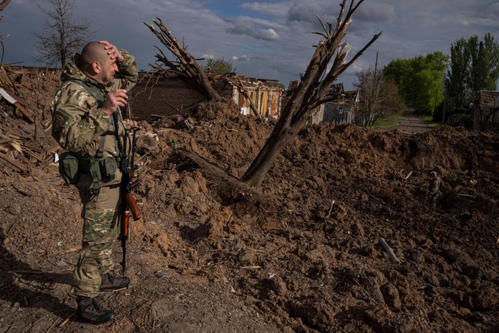 A Ukrainian serviceman inspects a site after an airstrike by Russian forces in Bahmut, Ukraine, on May 10, 2022.