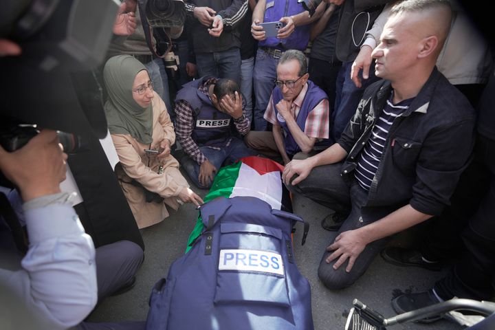 Journalists surround the body of Shireen Abu Akleh, a journalist for Al Jazeera network, into the morgue inside the Hospital in the West Bank town of Jenin, Wednesday, May 11, 2022. The well-known Palestinian reporter for the broadcaster's Arabic language channel was shot and killed while covering an Israeli raid in the occupied West Bank town of Jenin early Wednesday, the Palestinian health ministry said.